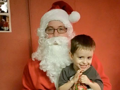 A picture of Santa with a child at SOCU