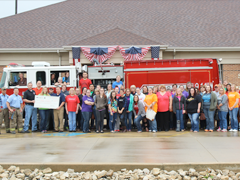 Employees present a check to Streator FD