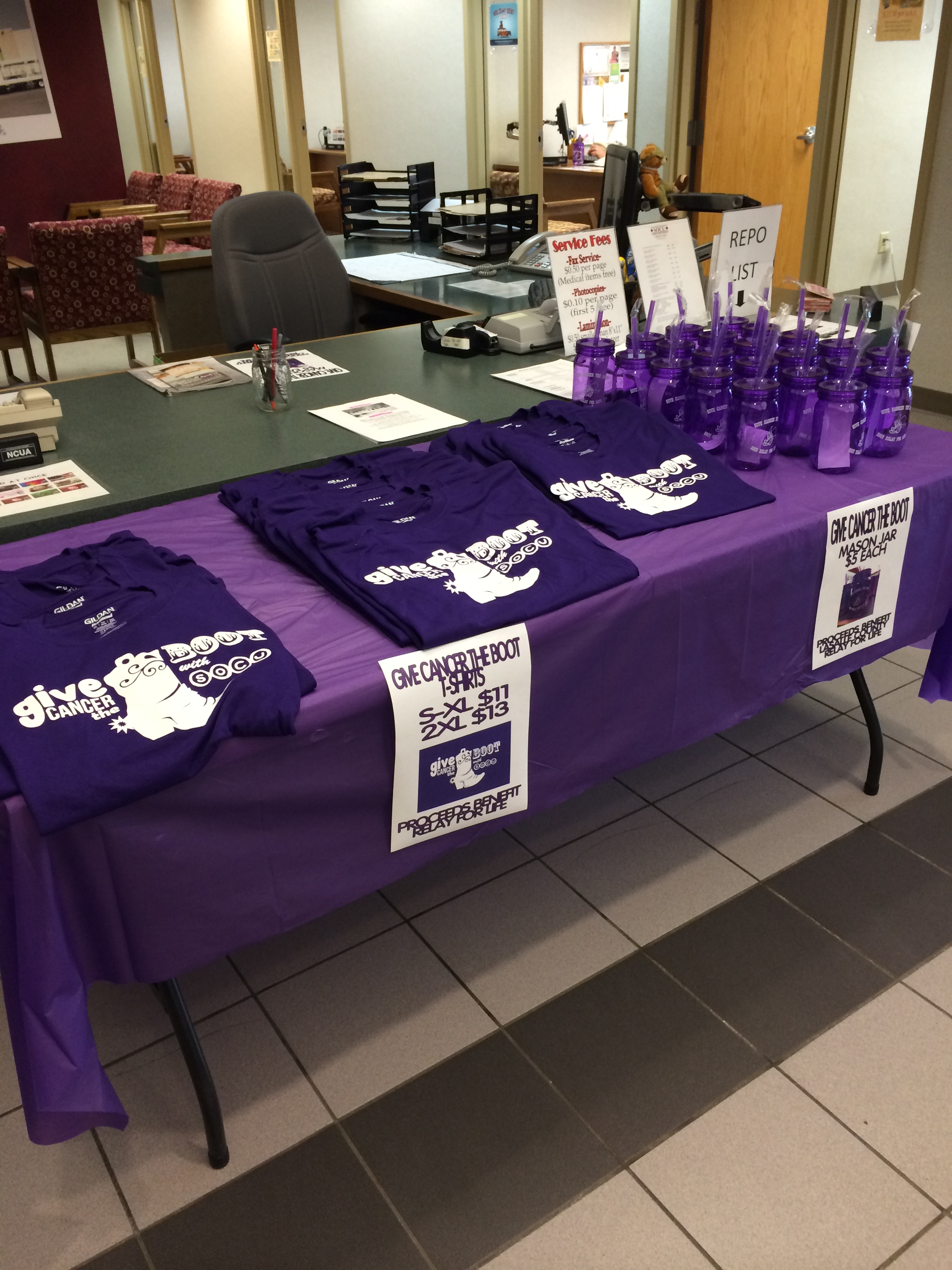 Give cancer the boot table with shirts and mugs for sale