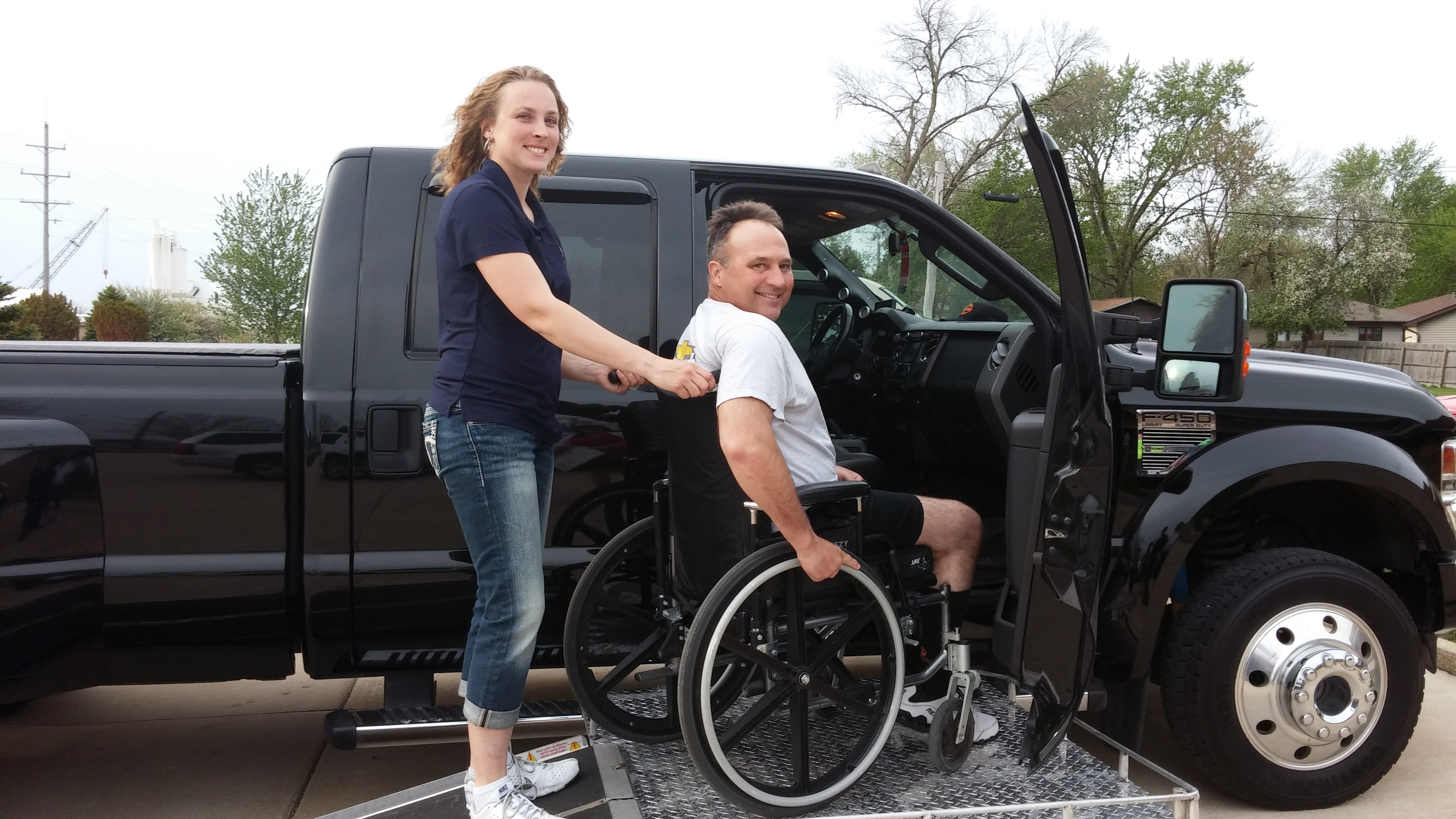 Of vet with wheelchair on ramp to truck