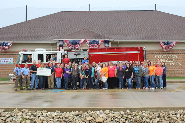 SOCU employees stand in front of the main branch with Streator Fire Department