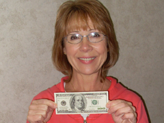 A member holding a dollar bill
